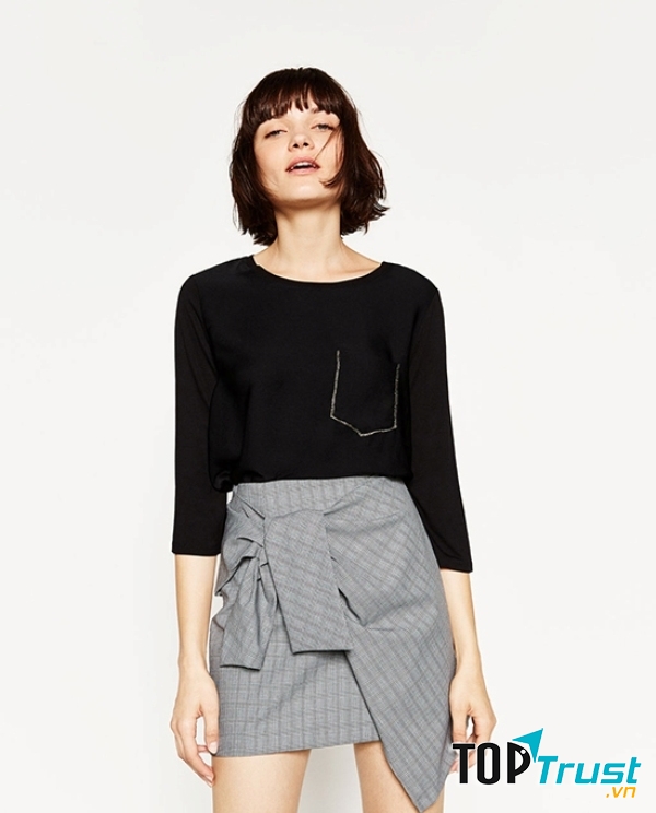 Áo thun đen có túi kết hợp hoàn hảo với những chân váy phá cách, hoặc quần short jeans có cạp cao đến ngang bụng