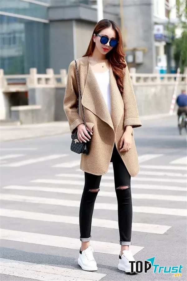 Set đồ đơn giản áo phông trắng và quần jean xắn gấu cùng đôi giày thể thao trắng quen thuộc nhưng khoác thêm chiếc áo khoác dáng dài là set đồ đã trở nên trendy rồi